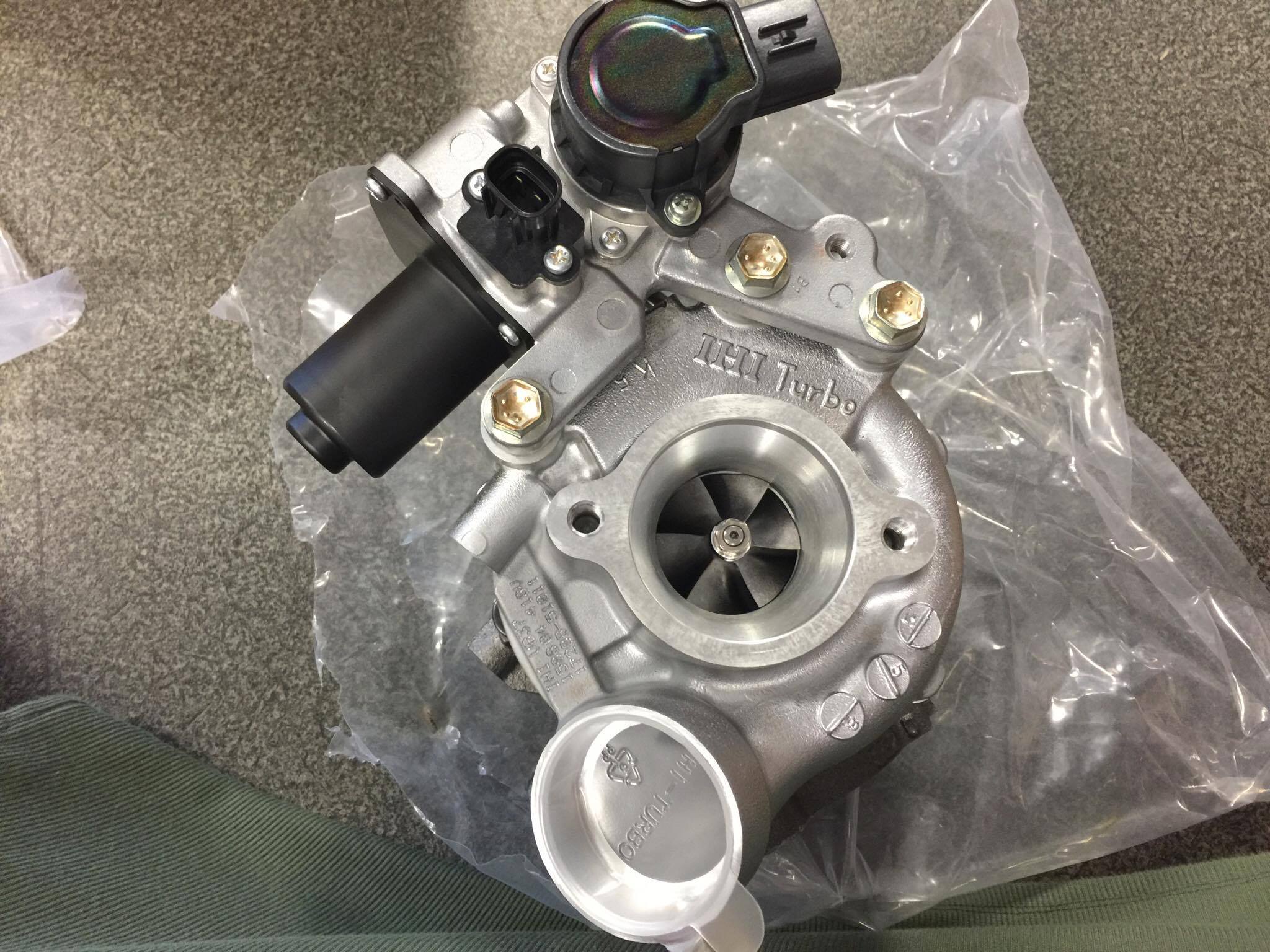 A new turbocharger unit, still in its packaging, at the workshop
