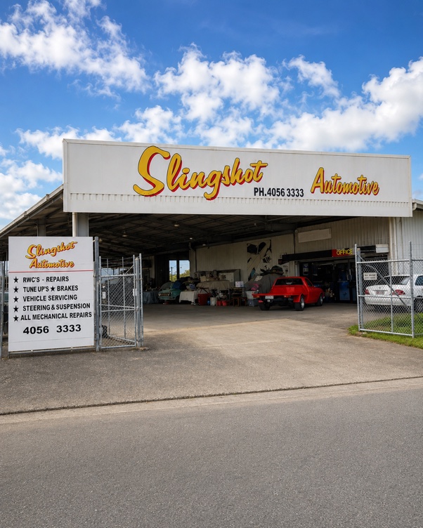 The Slingshot Automotive shed on Kern Street, with the painted sign and the service board at the gate